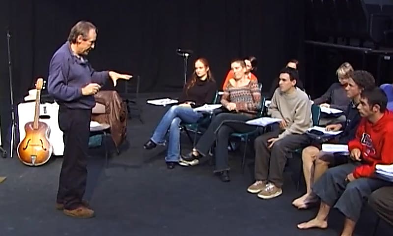 An industry expert teaching acting techniques to a group of students