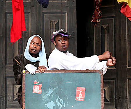 Two actors performing the production The Two Gentlemen of Verona in the language Shona at Shakespeare's Globe Theatre, London