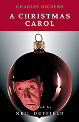 Scrooge's face is reflected in a Christmas ornament on the front cover of A Christmas Carol by Charles Dickens