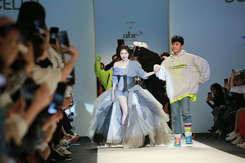 Actress/model Qin Lan and actor/designer Leo Ku Kui-Kei walk the runway during the Solo Celeb. & HTDG show on day five of Shanghai Fashion Week 2019 A/W