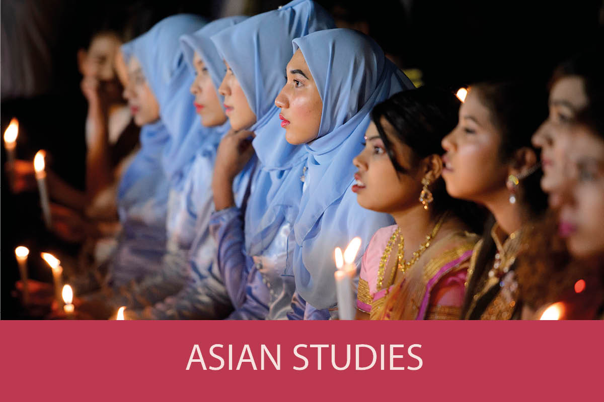 Hindu girls and Muslim girls hold candles as they take part in an Interreligious Gathering of Prayer for Peace ceremony in Yangon on October 31, 2017