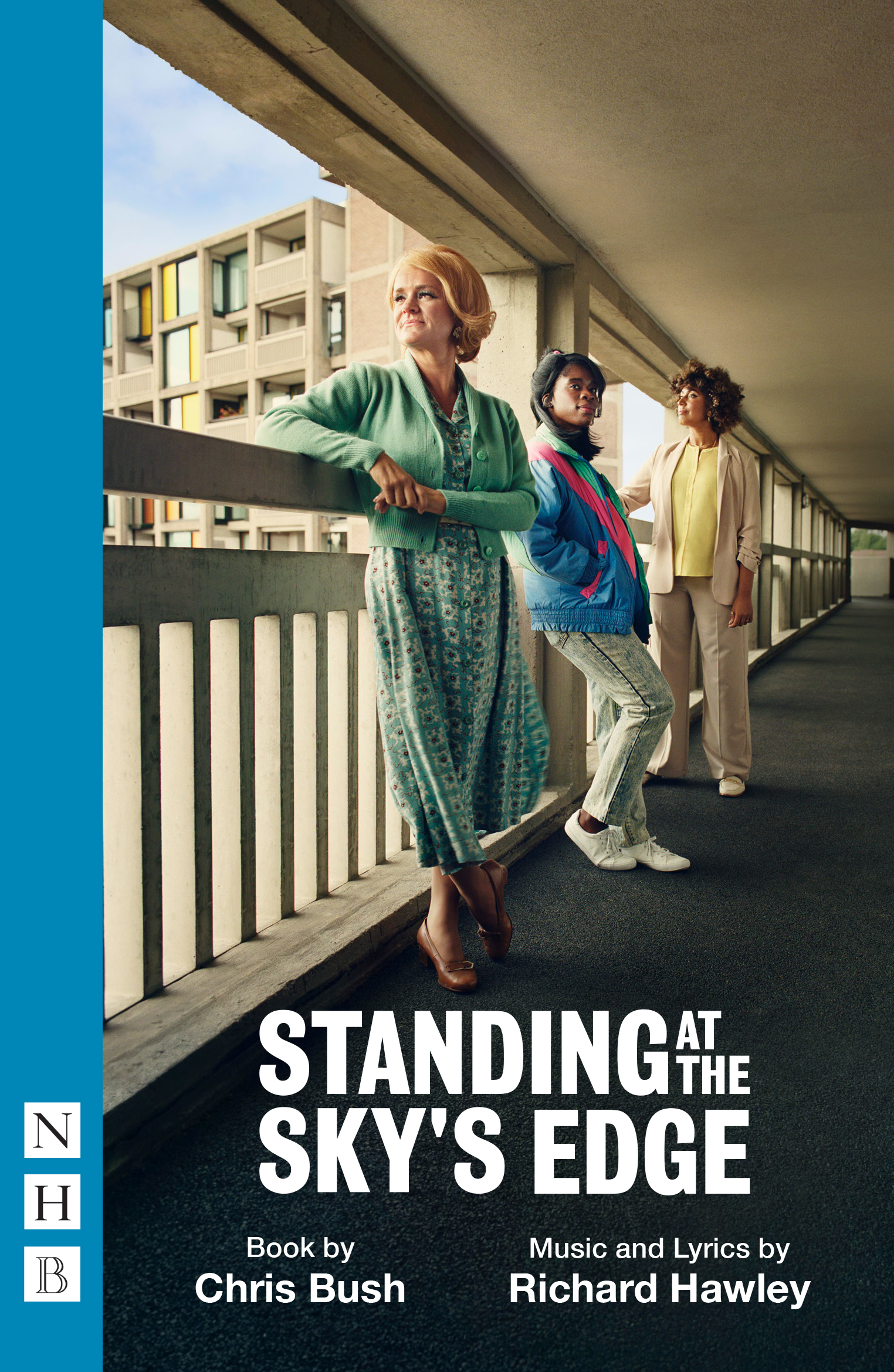 Cover of Standing At The Sky's Edge featuring three women standing in a balcony. Two of them are looking to the horizon and the third one is looking to one side