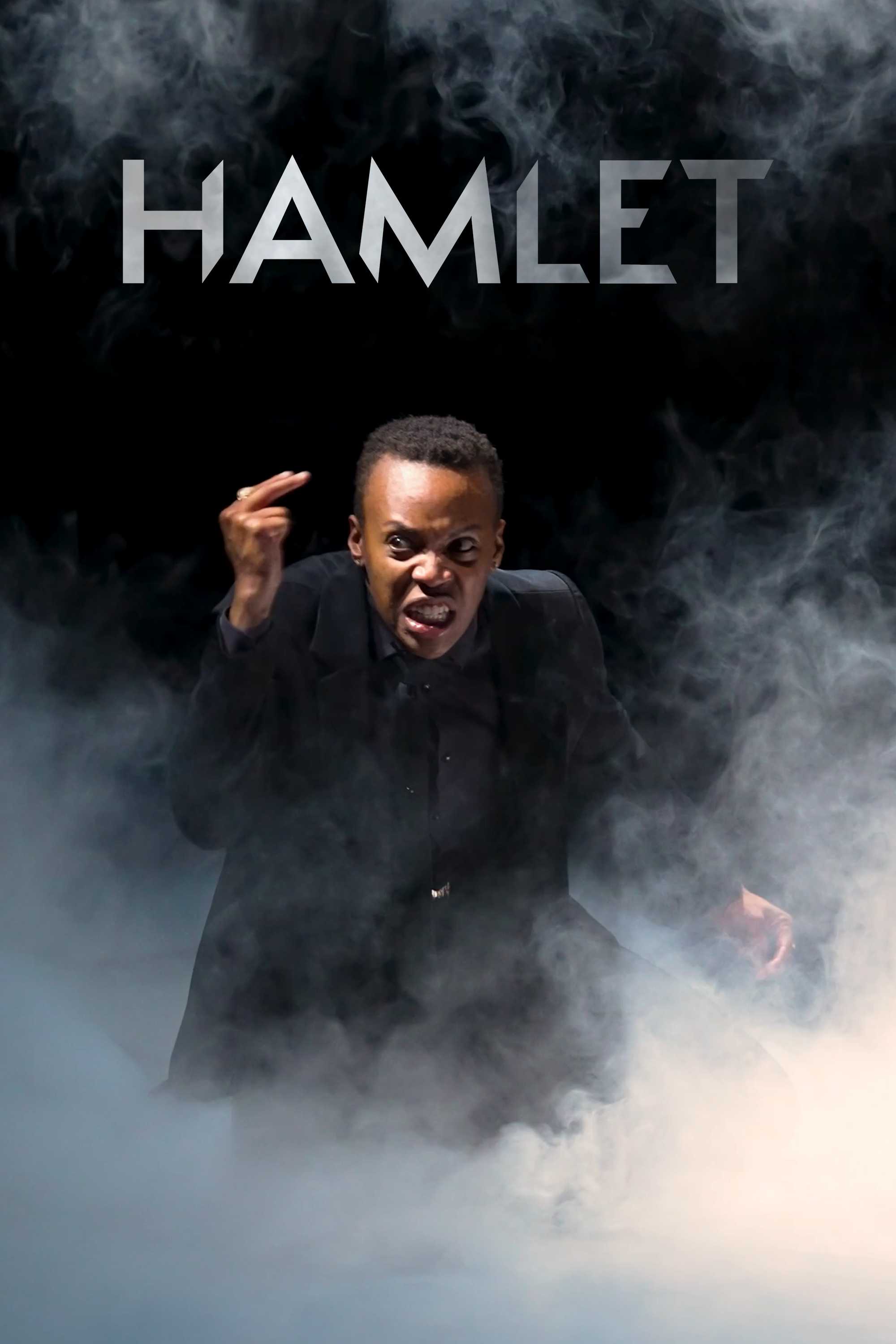 An actor with a strong facial expression, dressed in a dark suit, representing Hamlet for the Stratford Festival