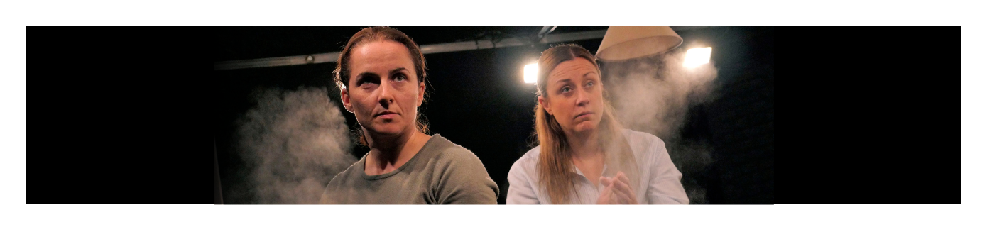 The face of two performers on a dark background with tense facial expressions