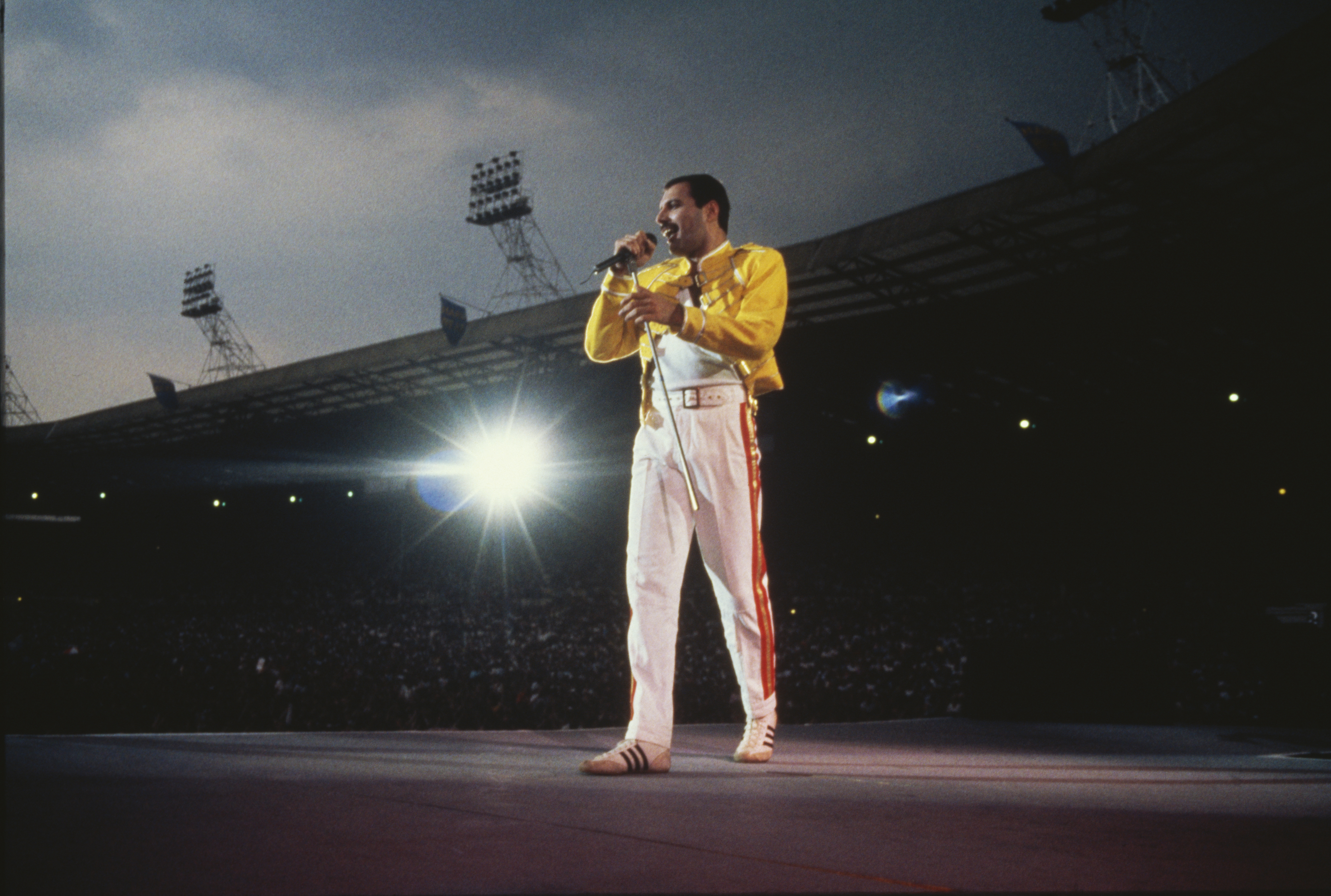 Singer Freddie Mercury performing with Queen at Wembley Stadium