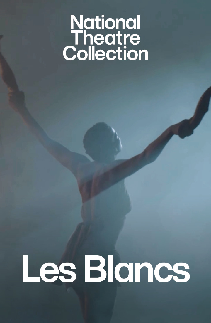 An actor standing in silhouette with their back turned away holding items in their hands starring in Les Blancs, a production recorded for the National Theatre