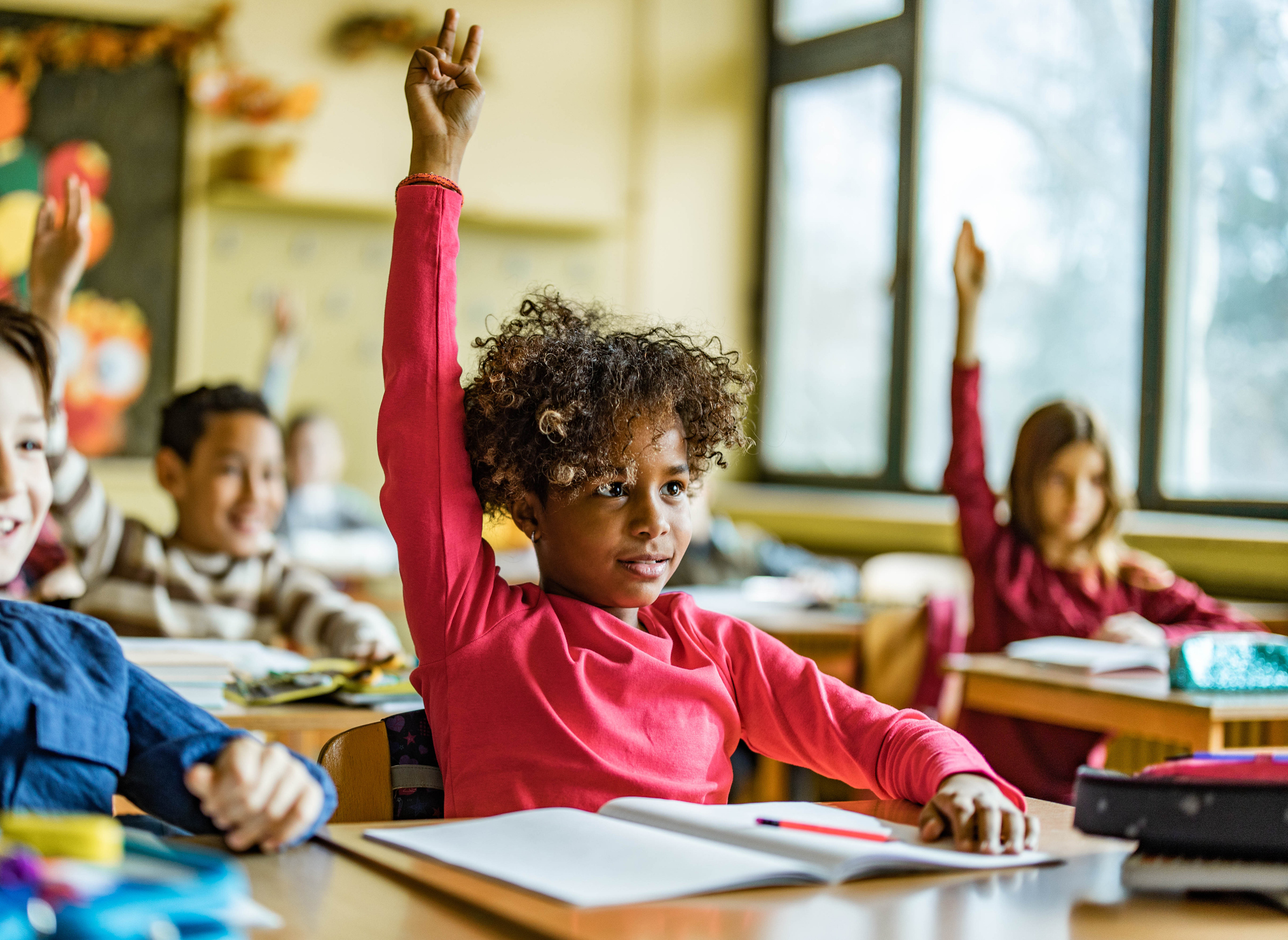 African American girl raising her hand