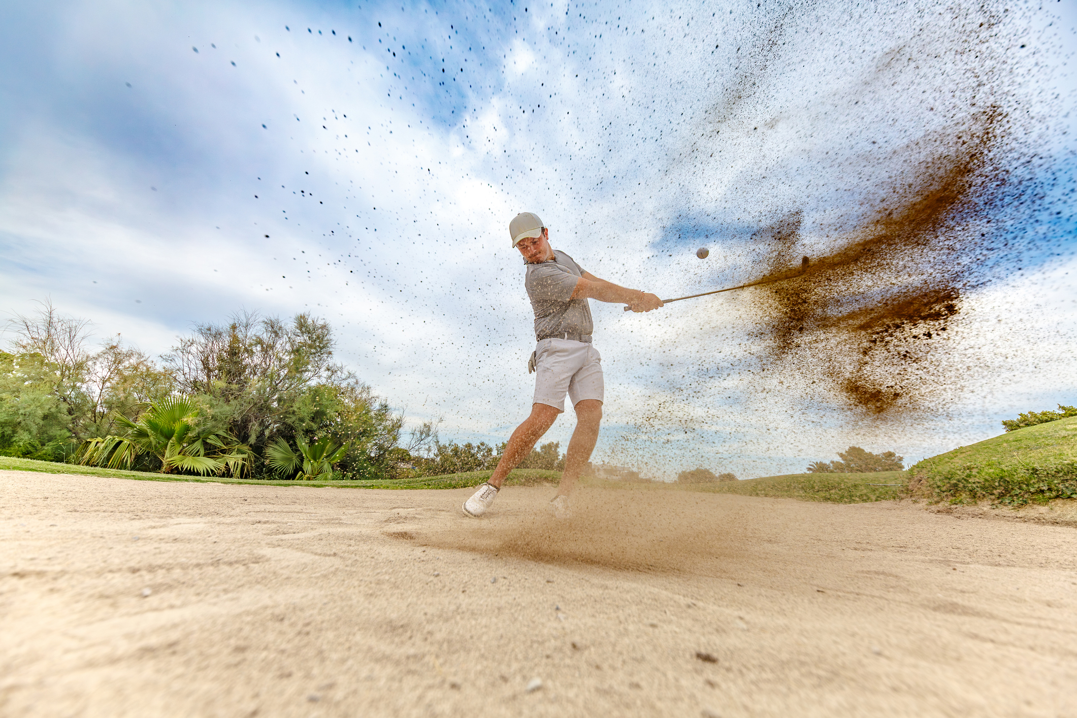 man golfer stuck in the sand