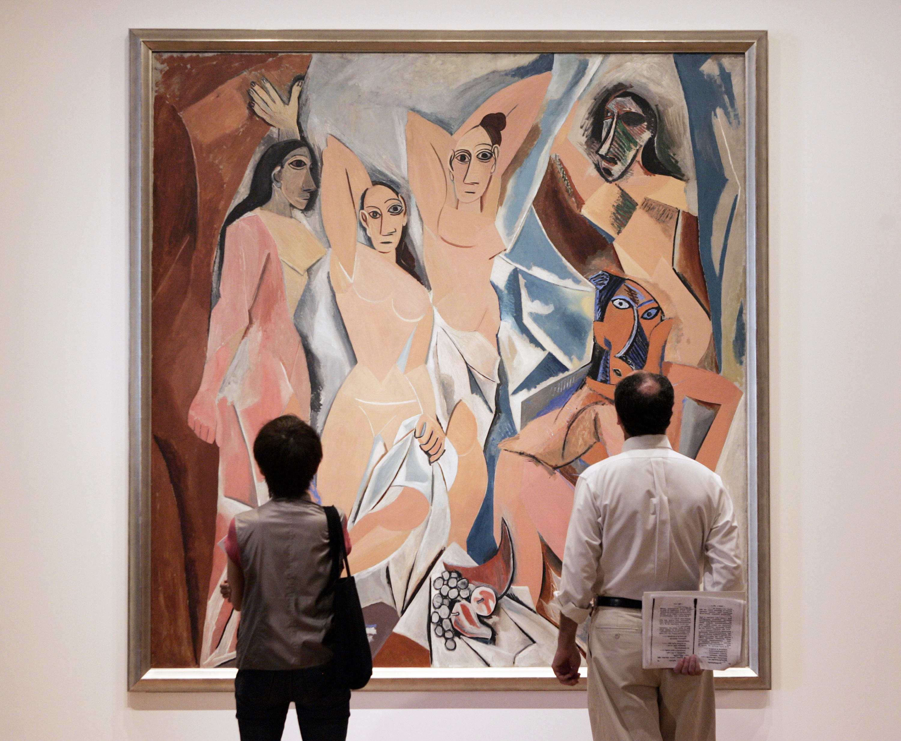 Photo of people looking at a work of art in a gallery or museum.