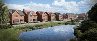 A tranquil pond with reeds in the foreground is bordered by a row of modern brick houses with manicured lawns and trees under a bright, cloudy sky.