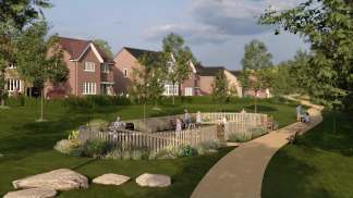 A residential neighborhood with well-maintained houses, lush greenery, and a winding path leading through a landscaped garden area in the foreground.