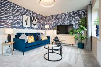 A modern and stylish living room with a blue velvet sofa, patterned wallpaper, and various decorative elements such as lamps, artwork, and a potted plant.