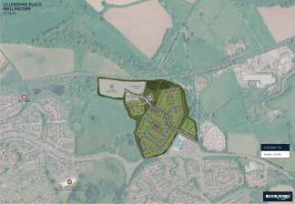 A detailed aerial map displays a planned housing development with roads and green spaces in the foreground, surrounded by existing residential areas, fields, and a distant industrial complex in the background.