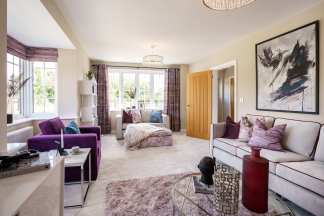 A modern living room with plush purple and grey furniture in the foreground and a large abstract painting on the wall in the background.