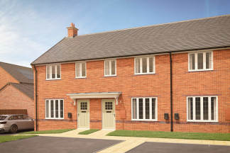 A row of modern brick townhouses with light green doors stands in the foreground, while a silver car is parked on a driveway to the left, and a clear blue sky with a few clouds is visible in the background.
