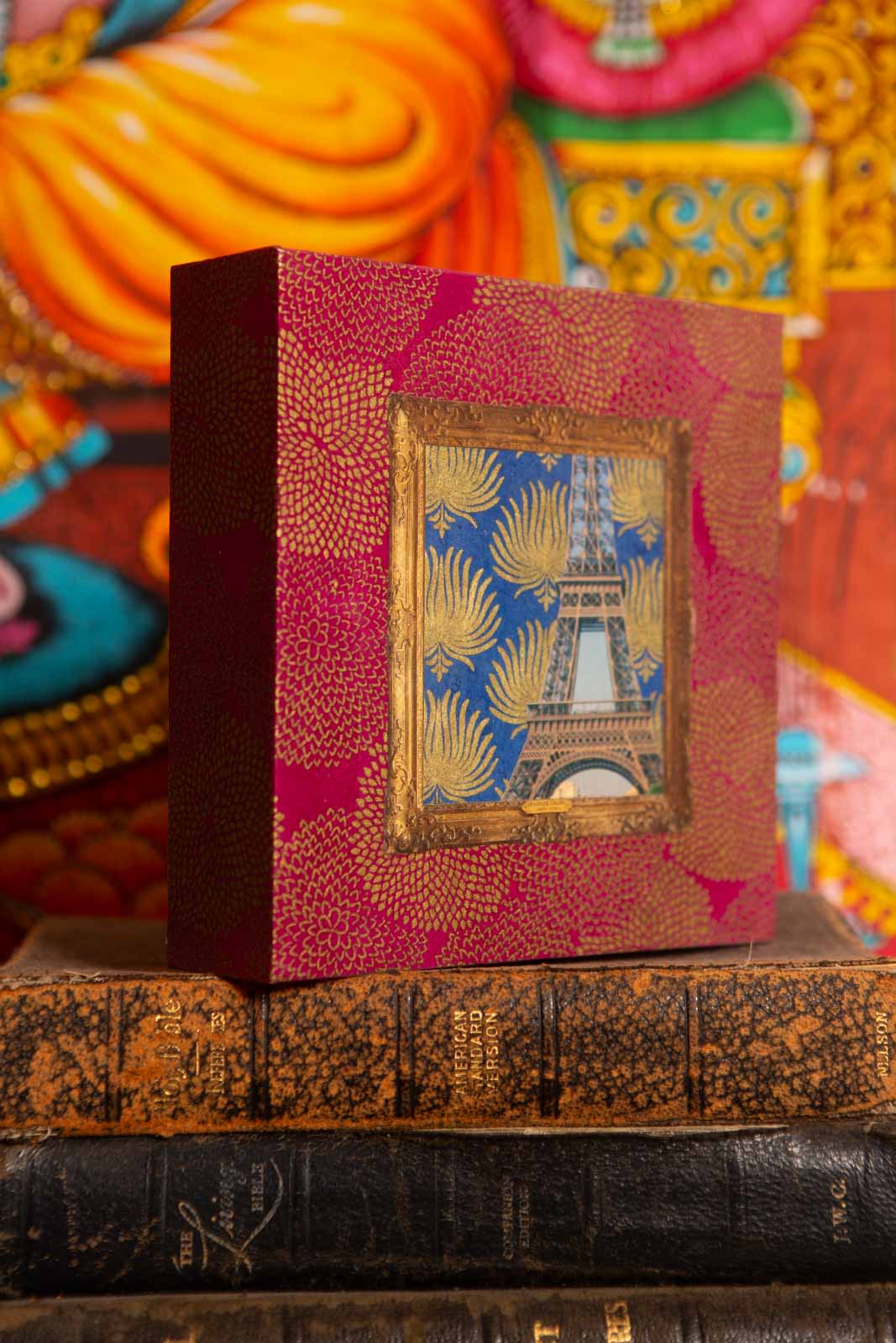 side view of a collage of the eiffel tower and pomegranate background