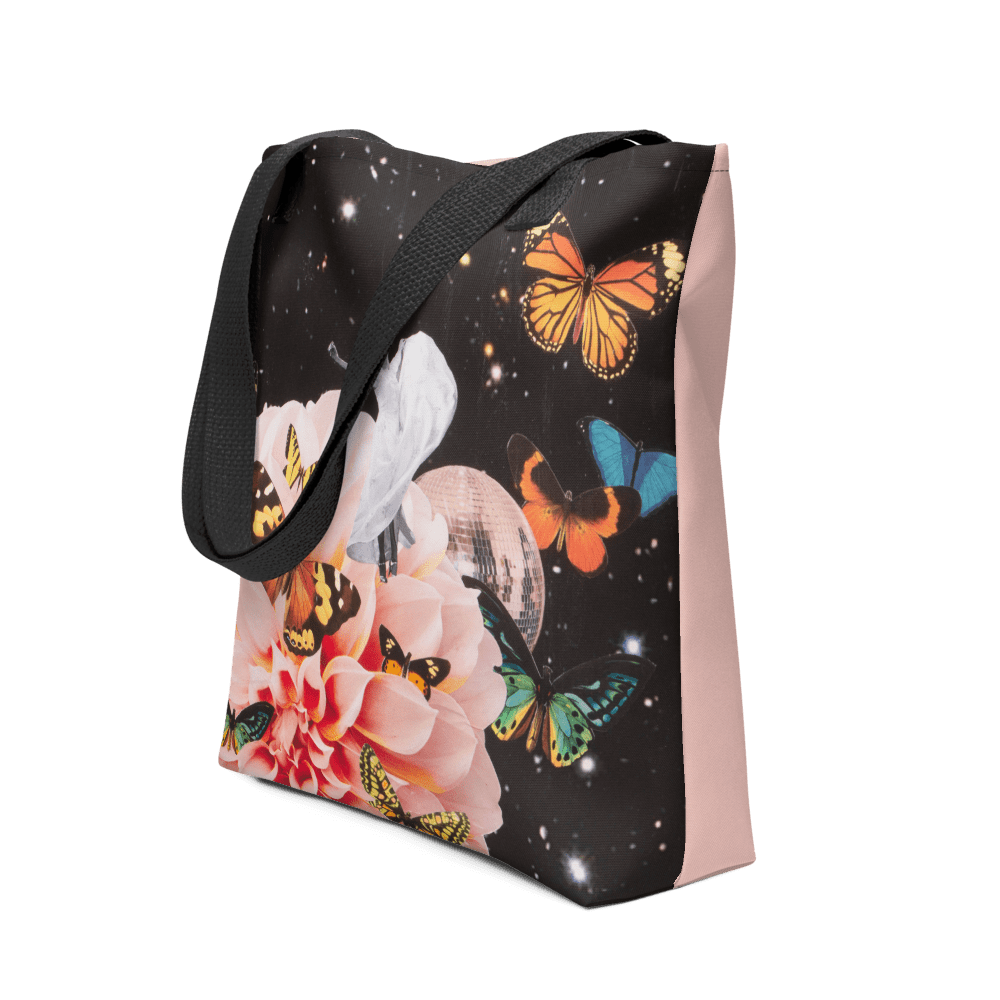 Three-quarter view of the tote, showing the night-sky collage on the front and the pale pink side panel