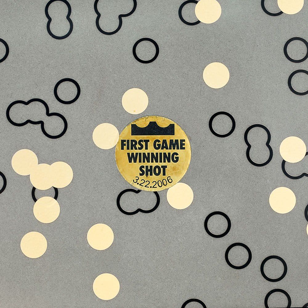 A gold circle containing the words “First Game Winning Shot” 