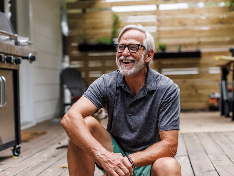 smiling senior man sitting on deck