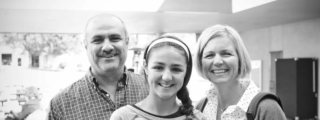 A multi-racial family posing for the camera in the courtyard at Blue Oaks Church in Pleasanton,CA