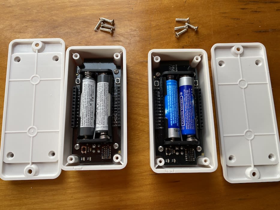 Two Reference Node enclosures with screws removed and batteries inserted