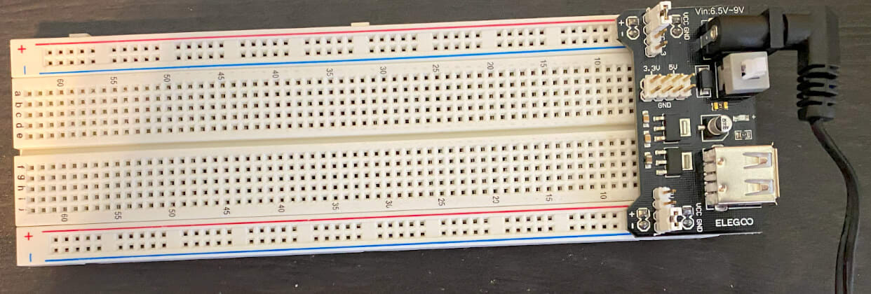 An assisted power source is connected to a breadboard