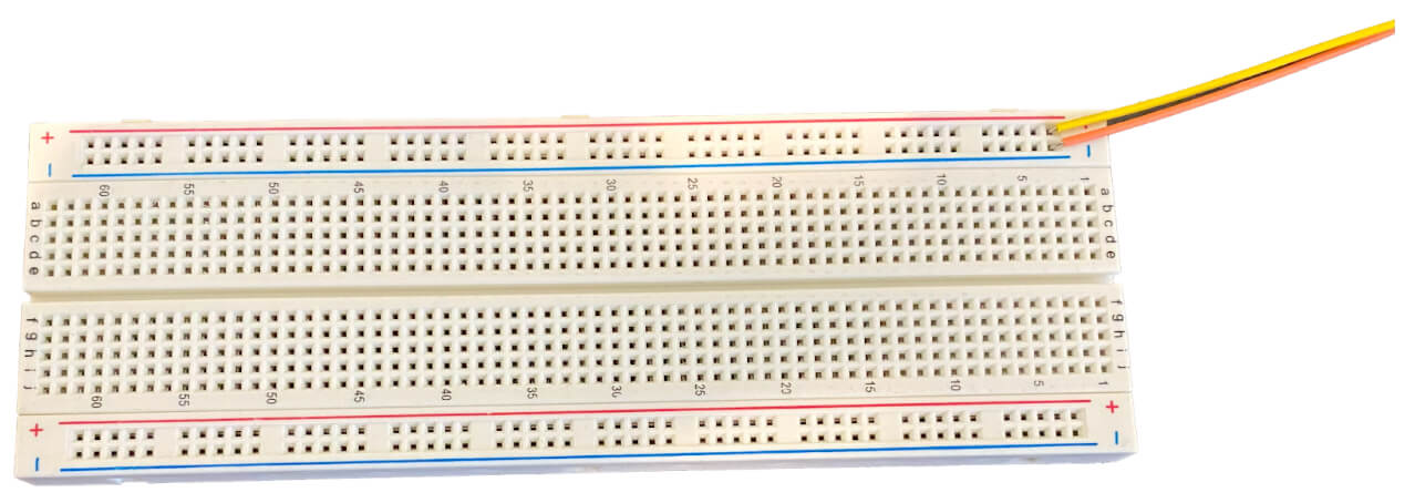 Manual wiring connects two wires to the end of a breadboard