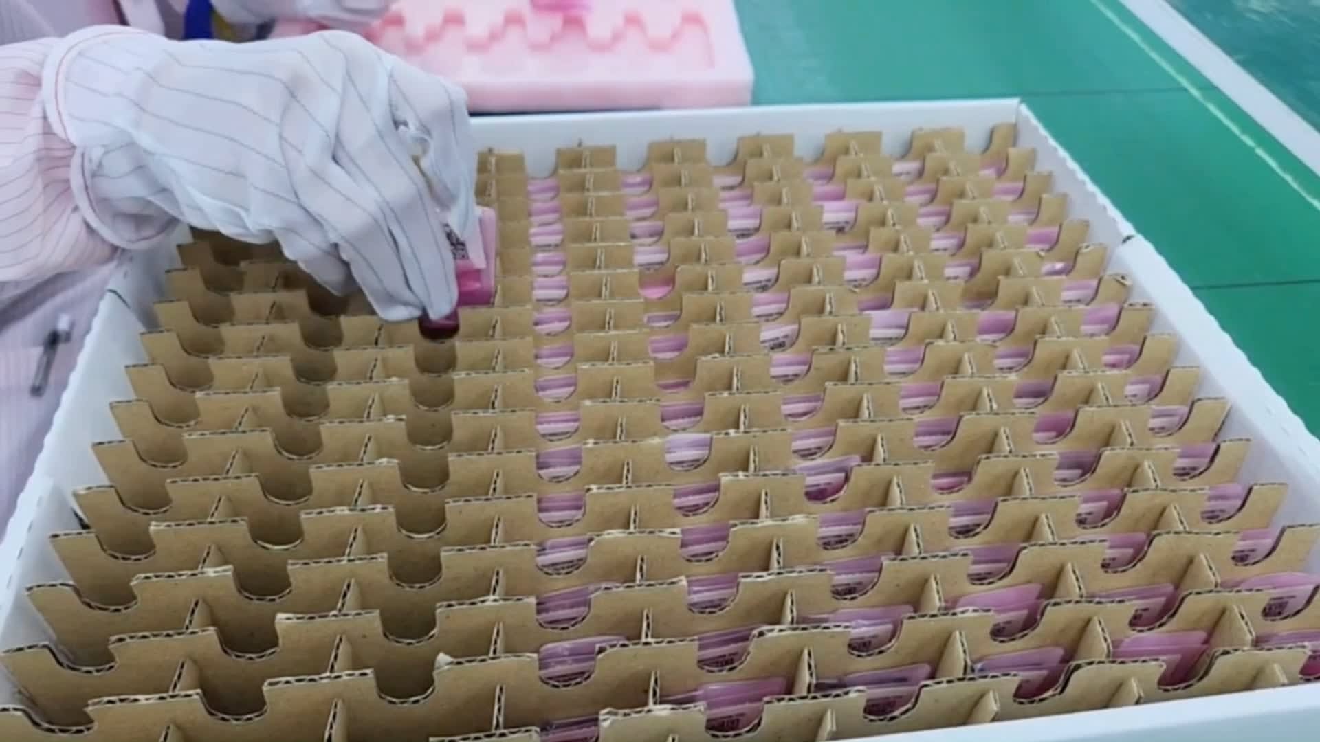 Notecards are packaged individually and loaded into trays for shipment.