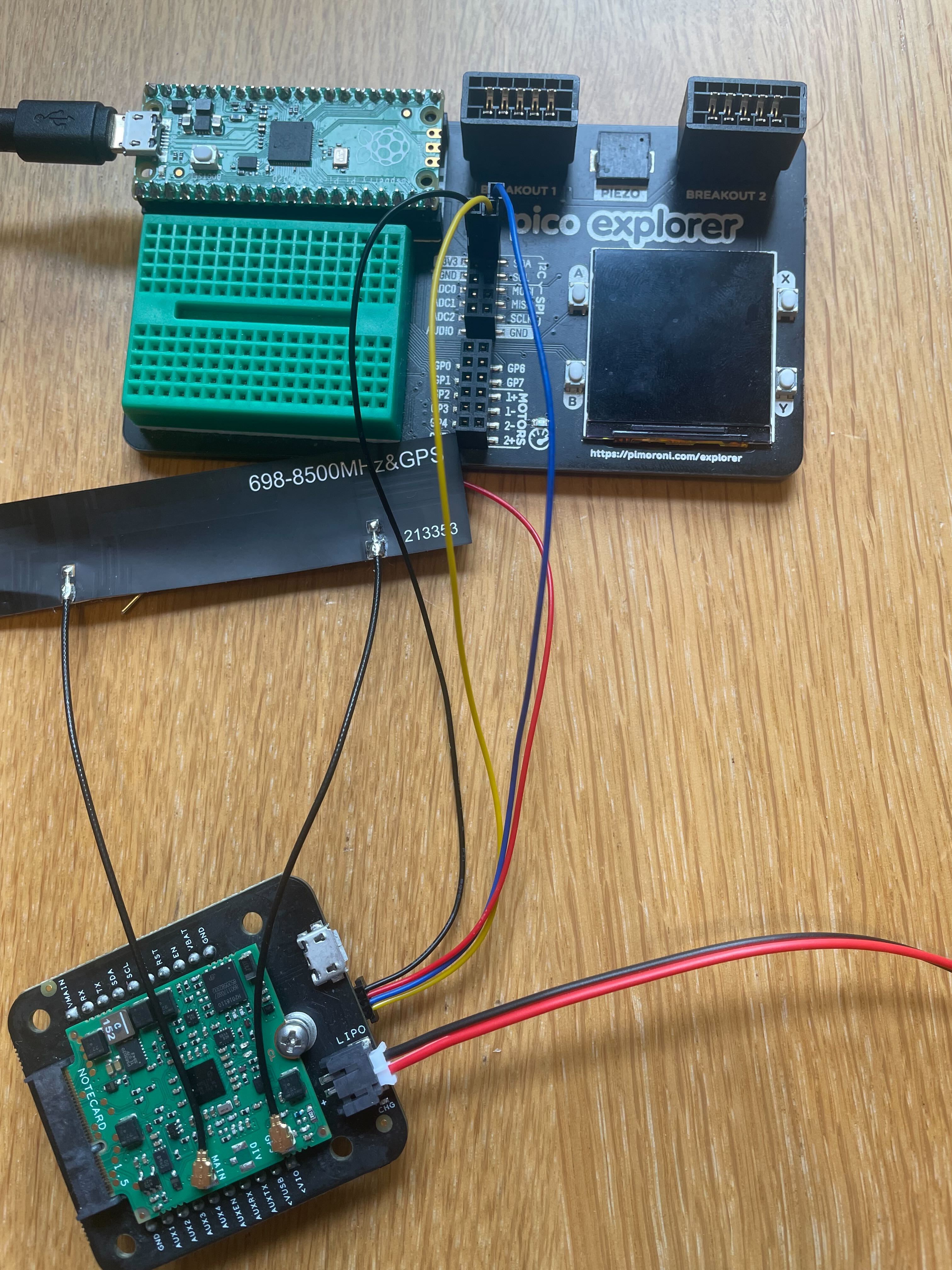 Picture of Blues Notecard on a Notecarrier B connected to a Raspberry Pi Pico in a Pimoroni Pico Explorer with a Qwiic to Breadboard cable