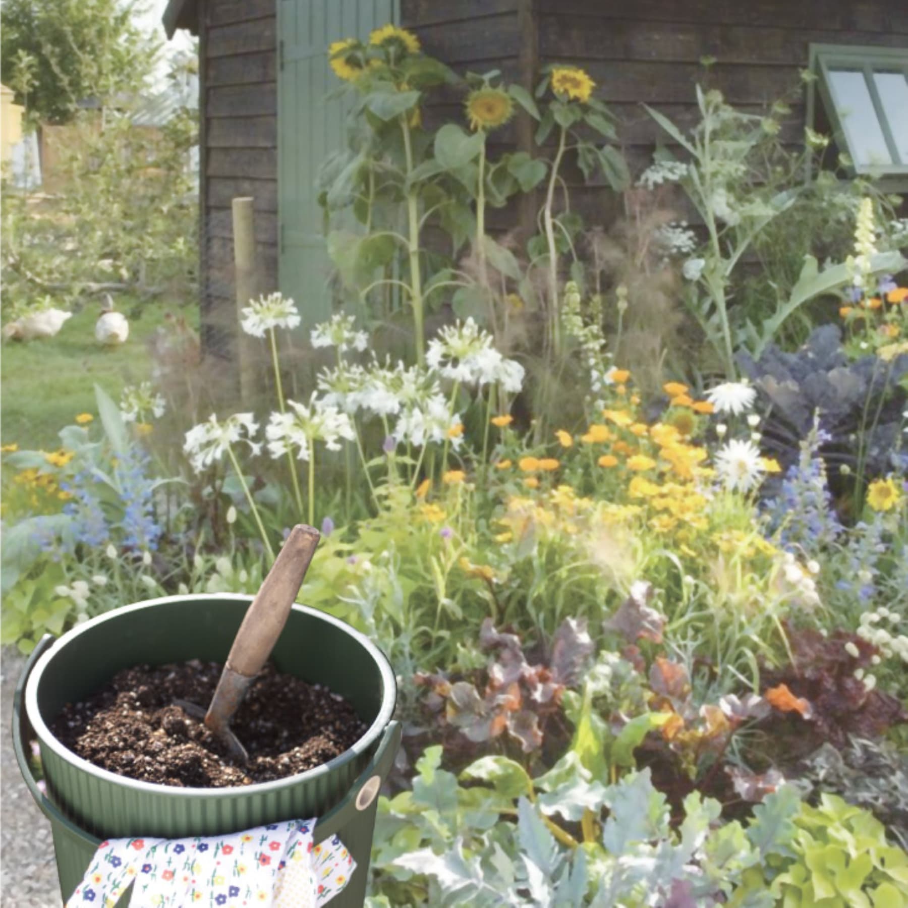 Ein üppiger, lebendiger Garten voller bunter Blumen und Pflanzen, darunter Sonnenblumen, Gänseblümchen und andere Blüten, mit einer kleinen Topfpflanze im Vordergrund.
