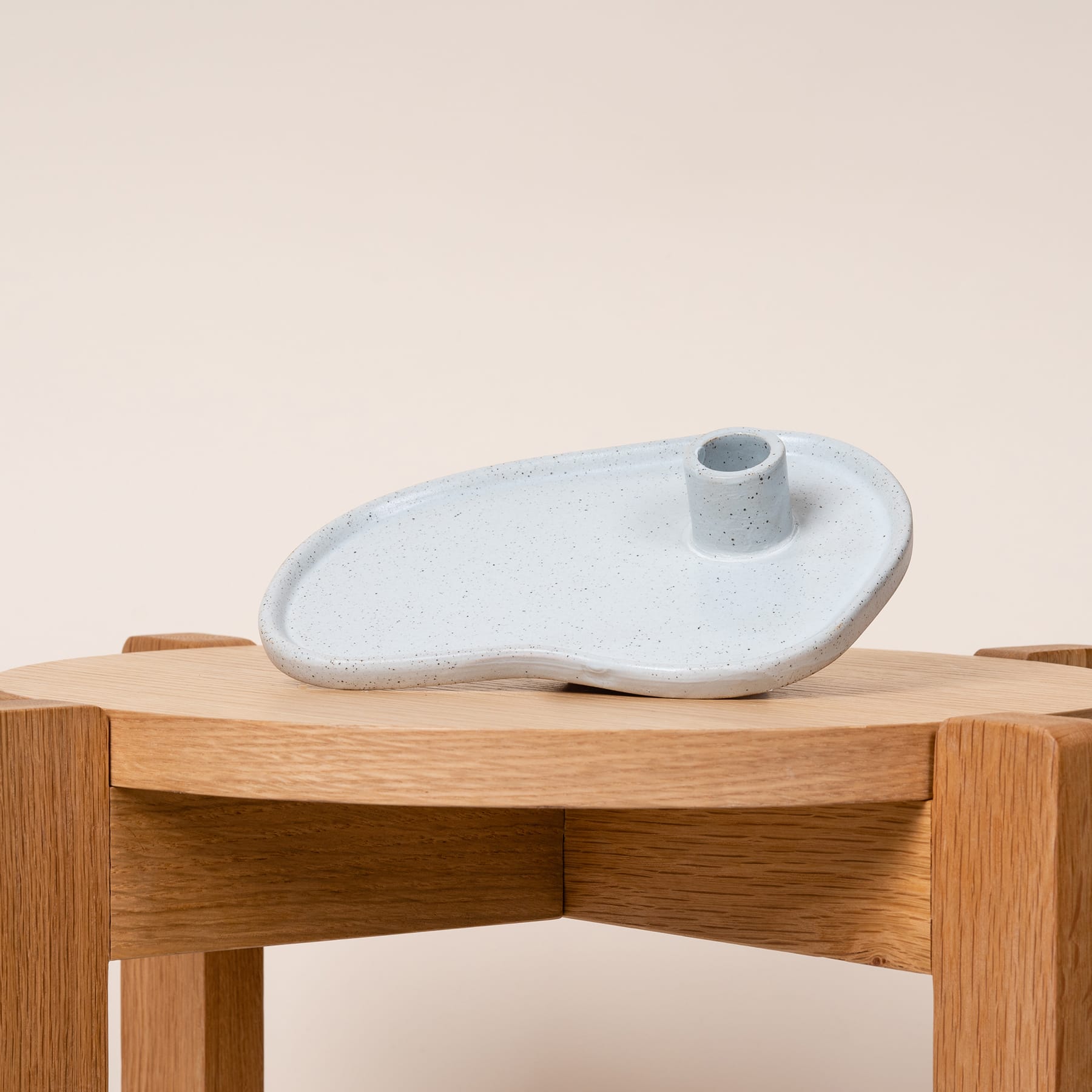 Auf einem Holztisch steht eine weiße Keramikschale, deren schlichtes und minimalistisches Design die natürliche Holzmaserung ergänzt.