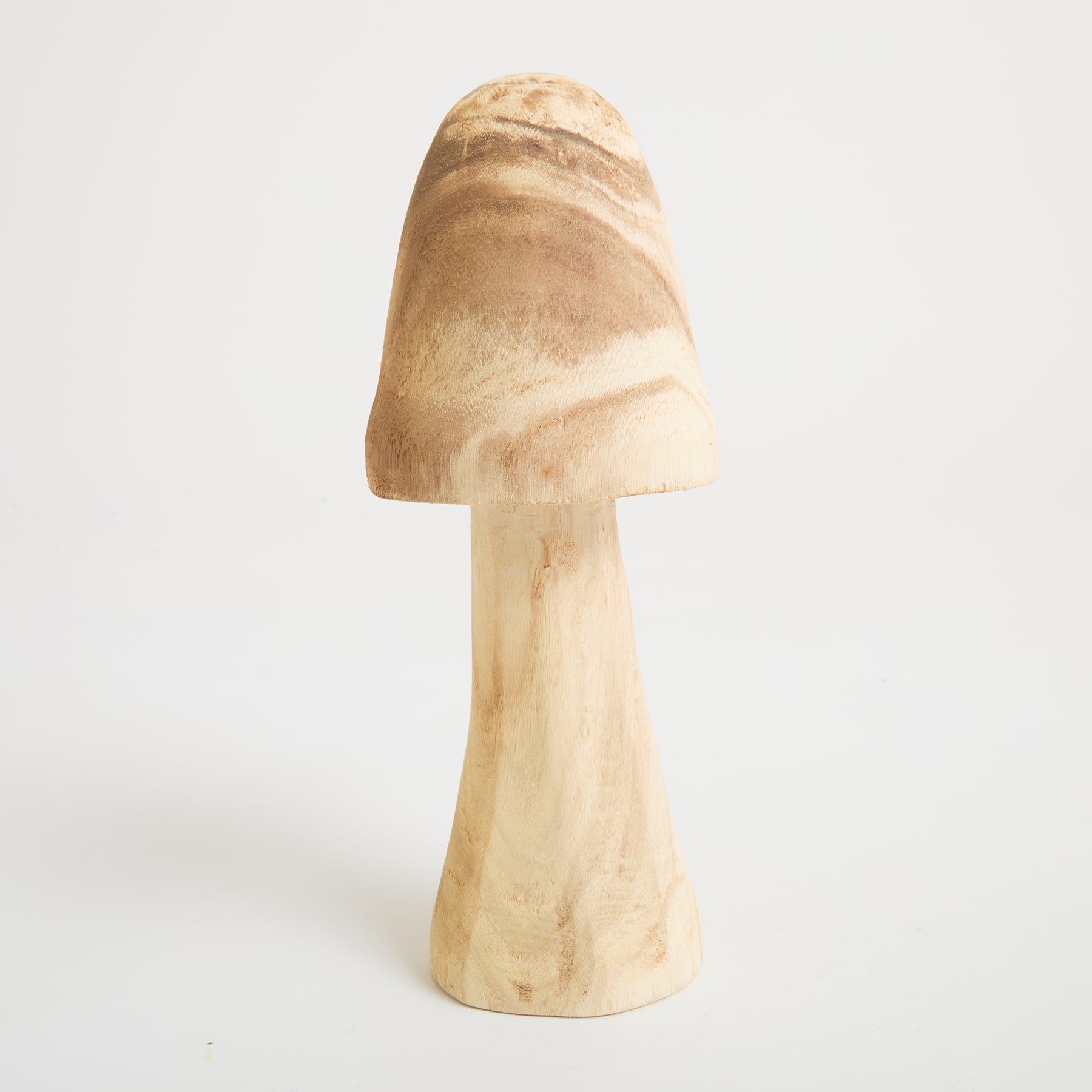 Ein helles, pilzförmiges Objekt steht allein auf einem schlichten weißen Hintergrund.