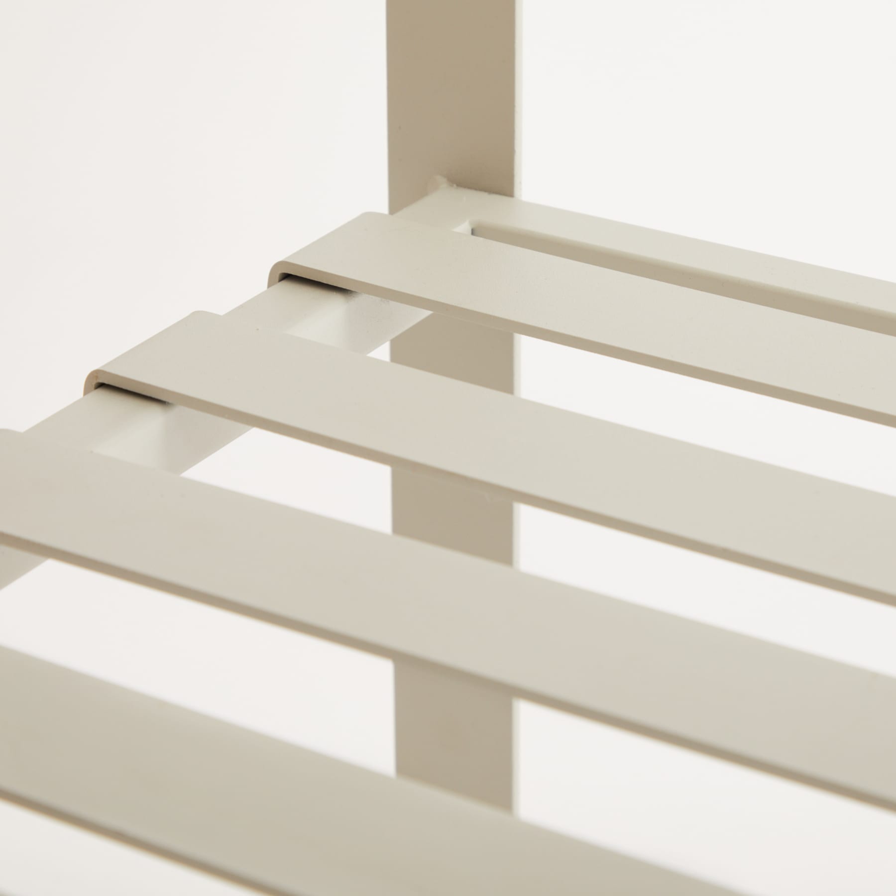 Das Bild zeigt ein minimalistisches, geometrisches Design mit einer Reihe beigefarbener, rechteckiger Lamellen, die in einem sich wiederholenden Muster angeordnet sind und so eine optisch beeindruckende und abstrakte Komposition erzeugen.