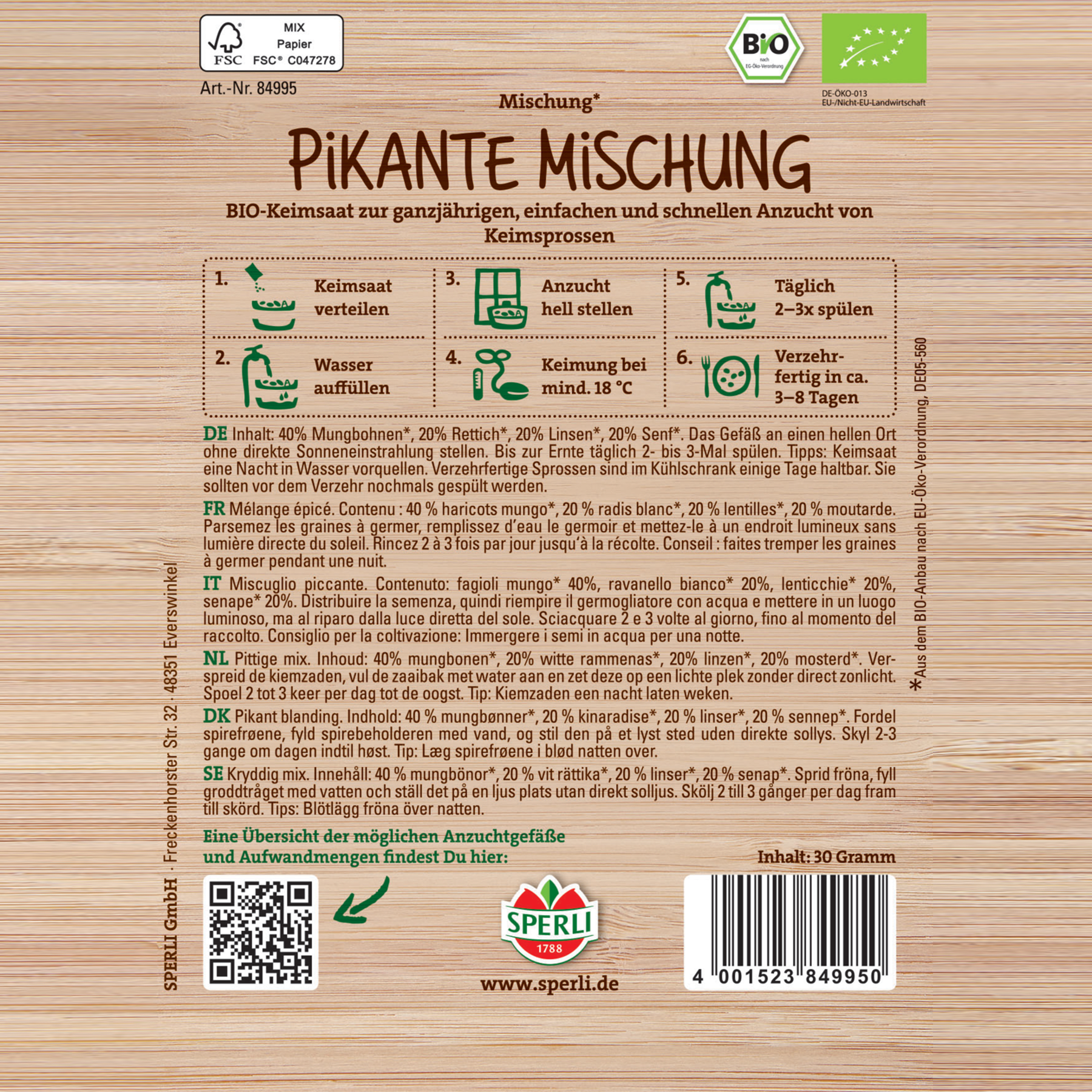 Auf dem Bild ist eine Holzkiste oder -kiste mit einem Etikett zu sehen, das offenbar für ein Produkt namens „Pikante Mischung“ bestimmt ist, bei dem es sich anscheinend um eine Art Gewürz- oder Gewürzmischung handelt.
