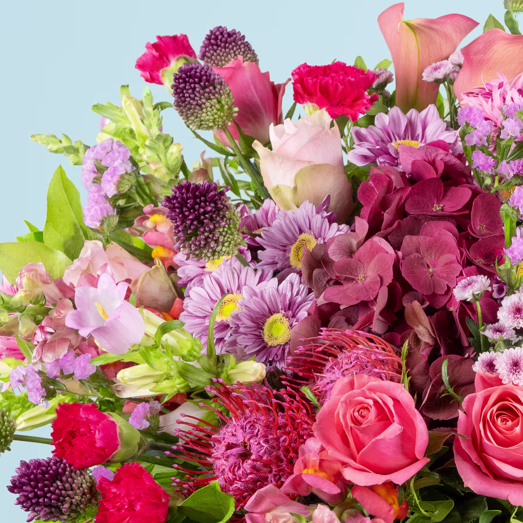 Ein lebendiger und farbenfroher Strauß verschiedener Blumen, darunter Rosen, Nelken, Chrysanthemen und andere Blüten, vor einem sanften blauen Hintergrund. (Beschreibungstext KI-generiert)