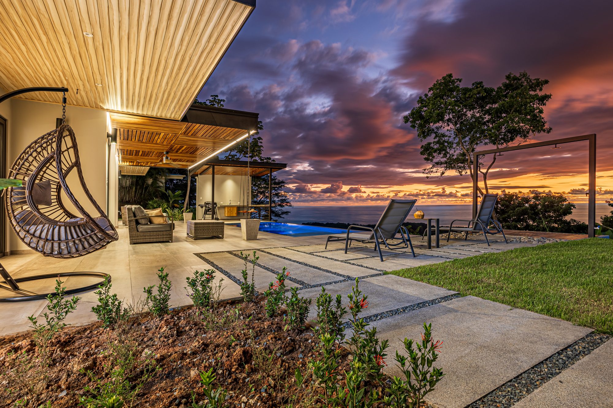 Infinity pool terrace with ocean sunset view in Costa Rica.