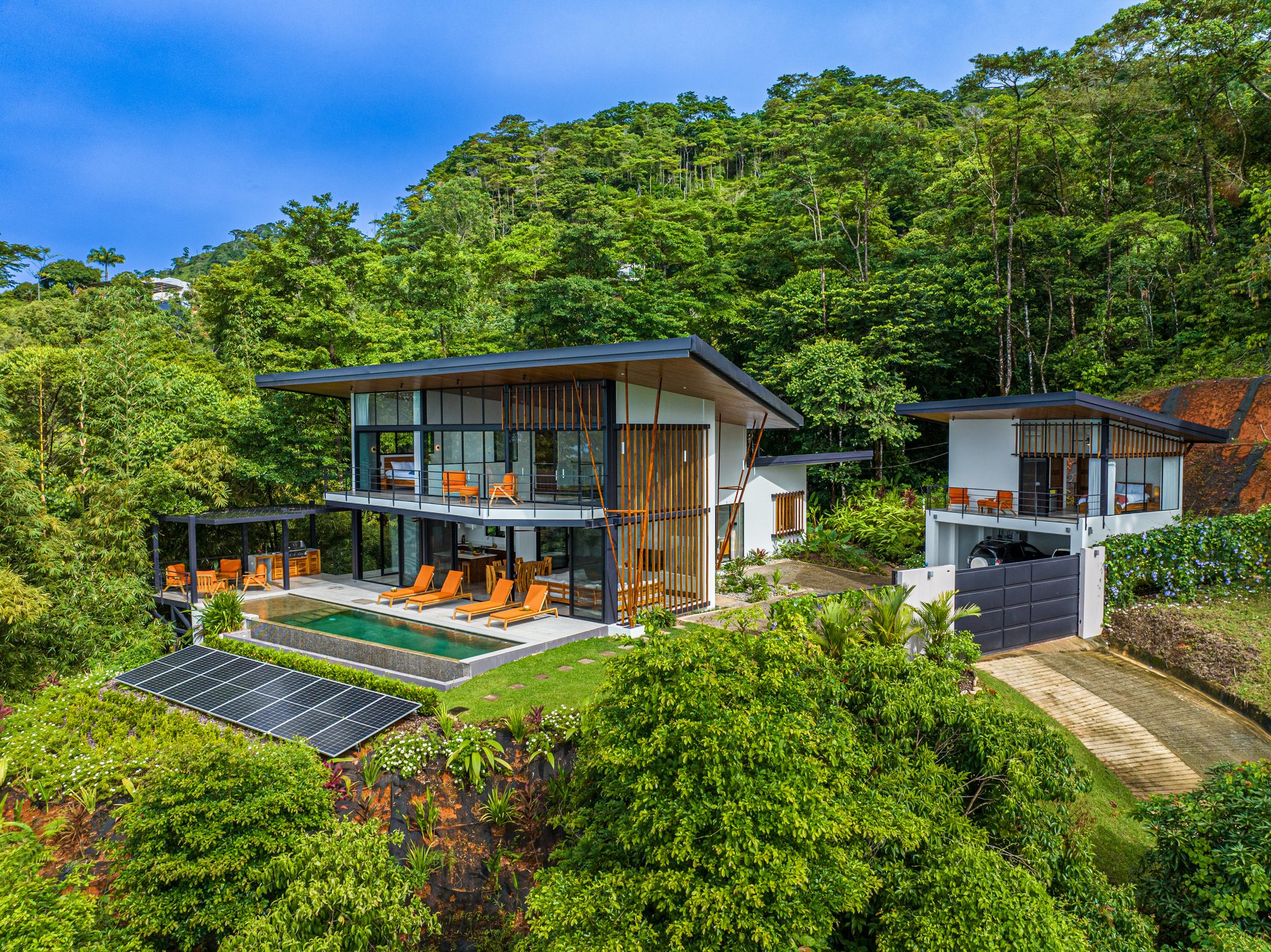 Aerial view of a modern villa with pool surrounded by tropical jungle in Costa Rica.