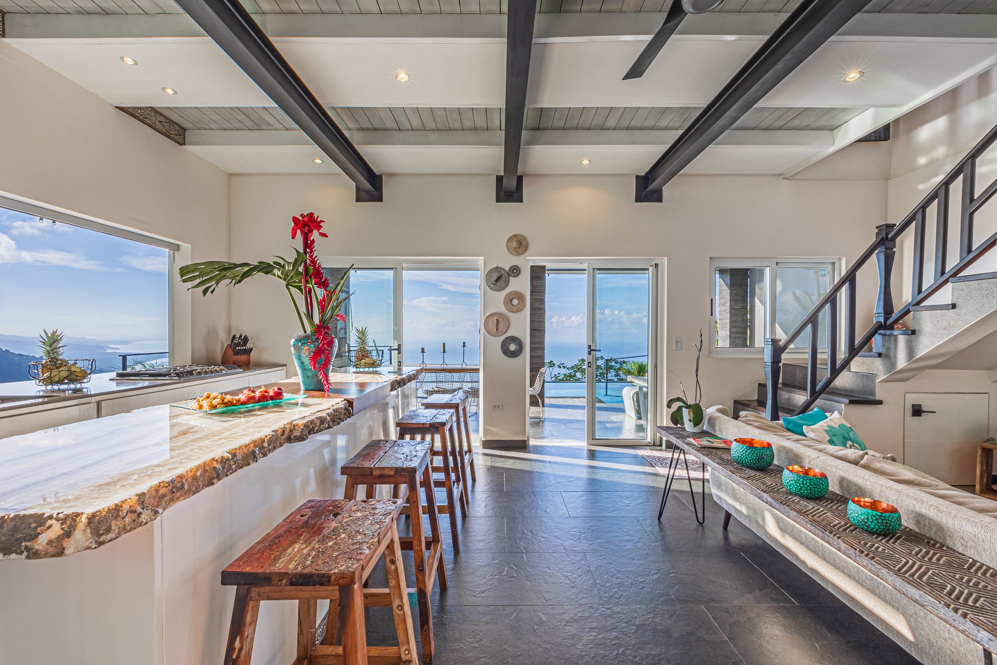 Modern kitchen with marble bar and panoramic ocean view from the mountains.