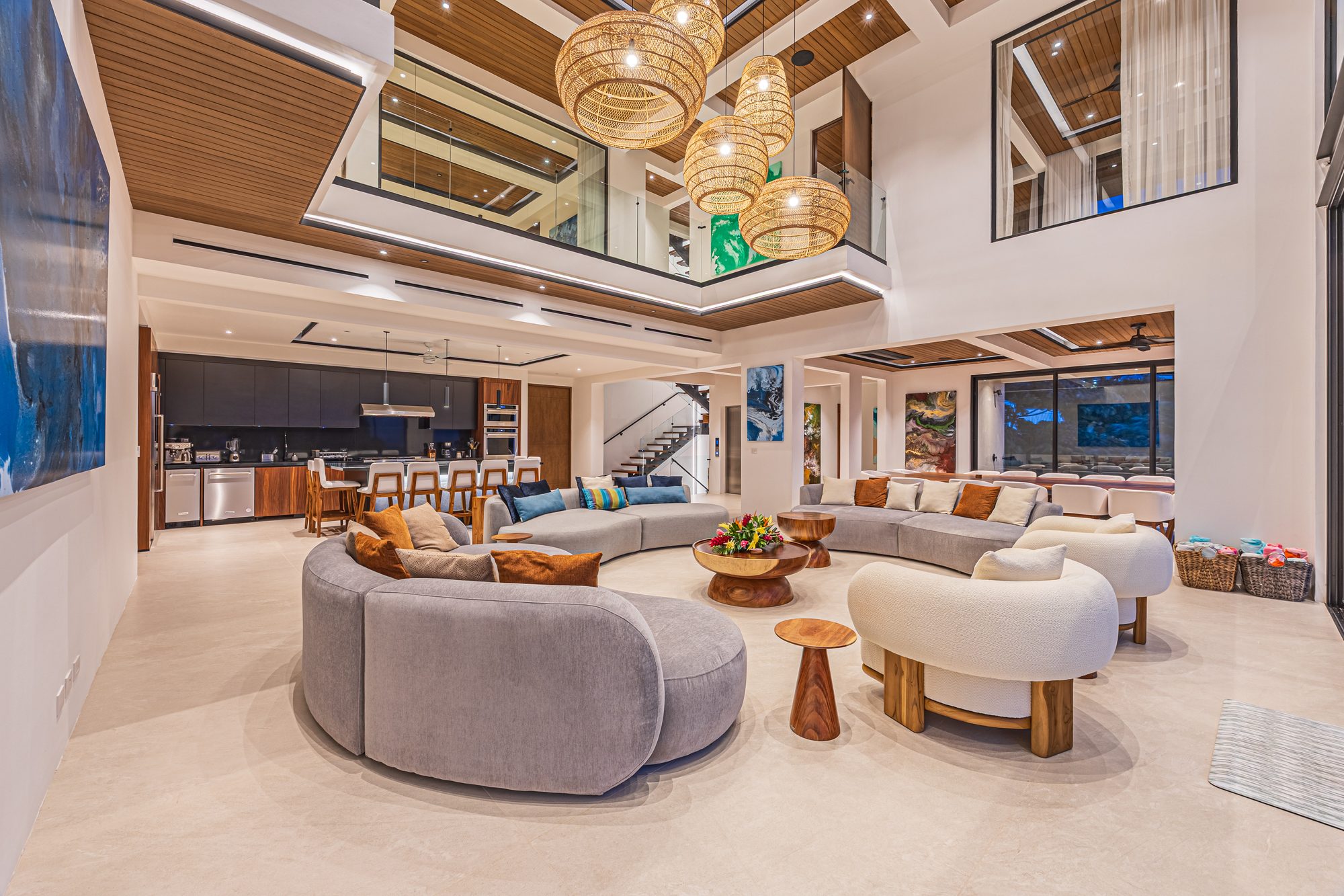Spacious double-height living room with open kitchen and modern furniture.