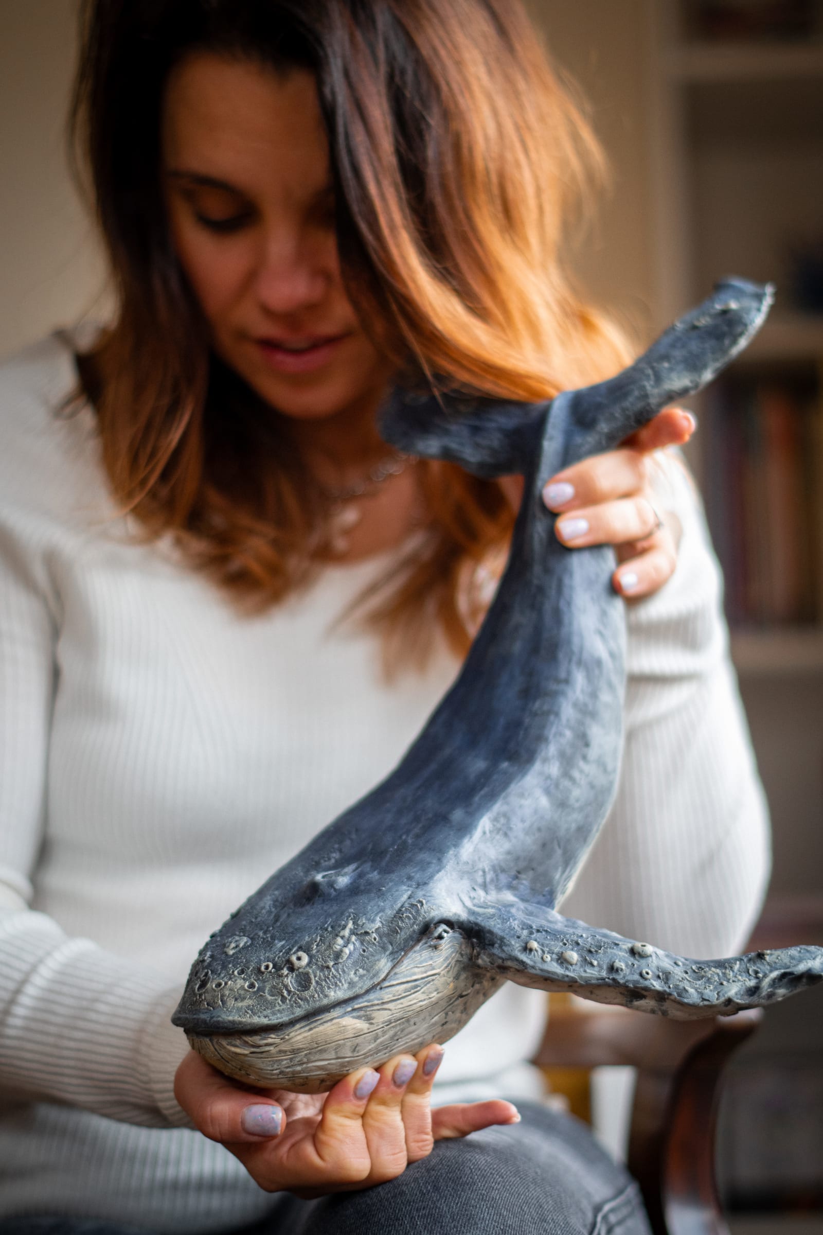 Olya Kivlin holding her hand-built ceramic whale