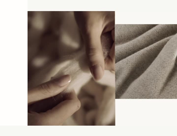 video background image - Detail close up of Reserve Alpaca Throw Blanket and a video of hands pulling wool
