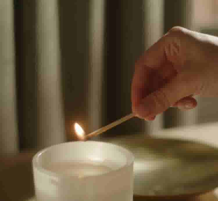 video background image - Person lighting a Boll & Branch candle