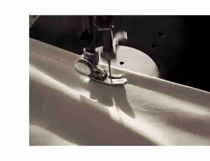 video background image - A antique sewing machine sewing onto fabric