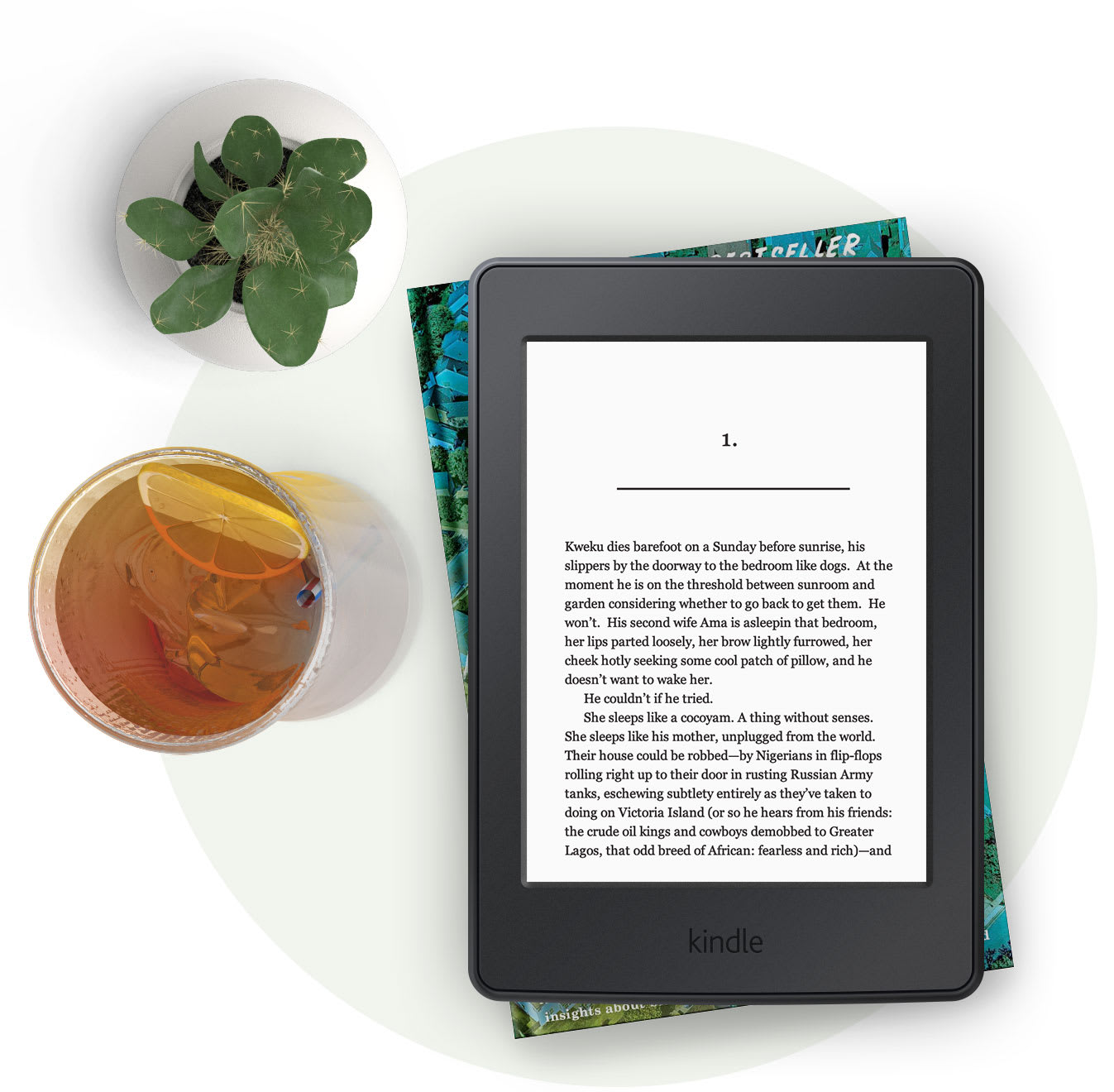 Kindle e-reader with a glass of iced tea