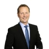 En profilbild av fastighetsmäklare Hans Berggren