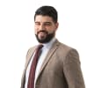 En profilbild av fastighetsmäklare Behrang Jamal