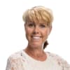 En profilbild av fastighetsmäklare Camilla Janzon