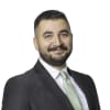 En profilbild av fastighetsmäklare Redir Ali