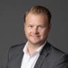 En profilbild av fastighetsmäklare Björn Ericsson