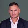 En profilbild av fastighetsmäklare Andreas Özgun